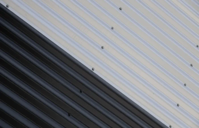 aluminum siding close up of junction of black and white corrugated