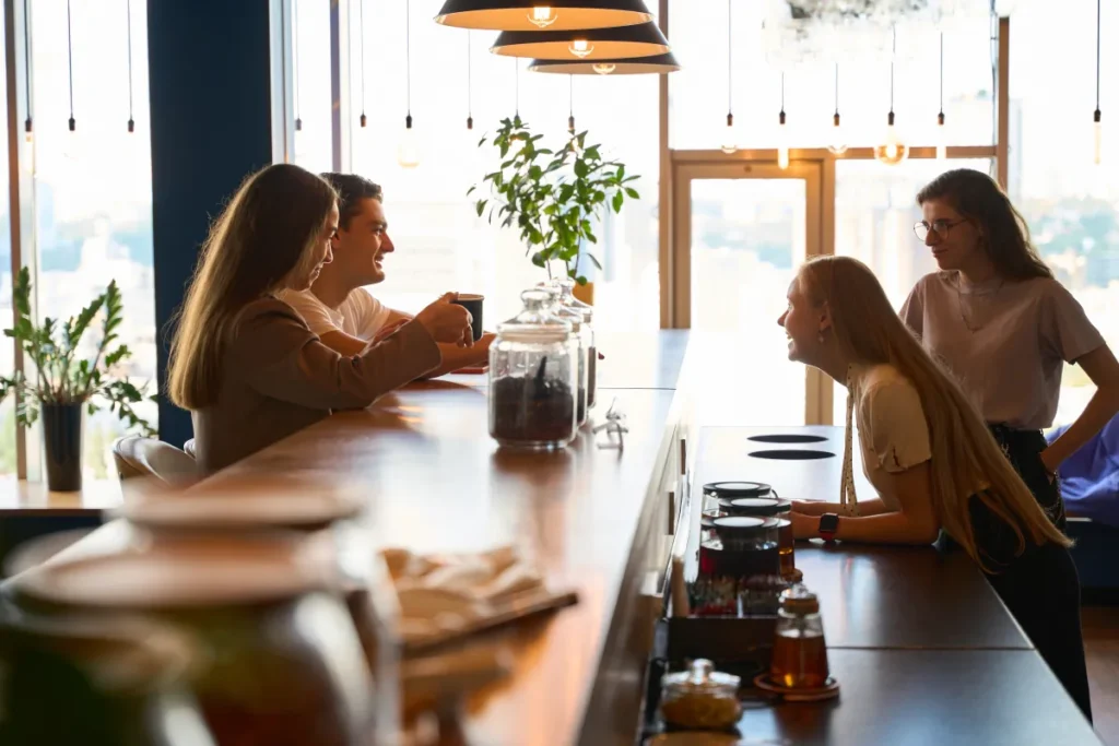 bar cafe build outs woman laughing next three friends bar