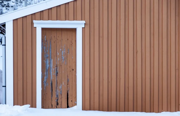 board batten siding weathered yellow wooden wall decay door