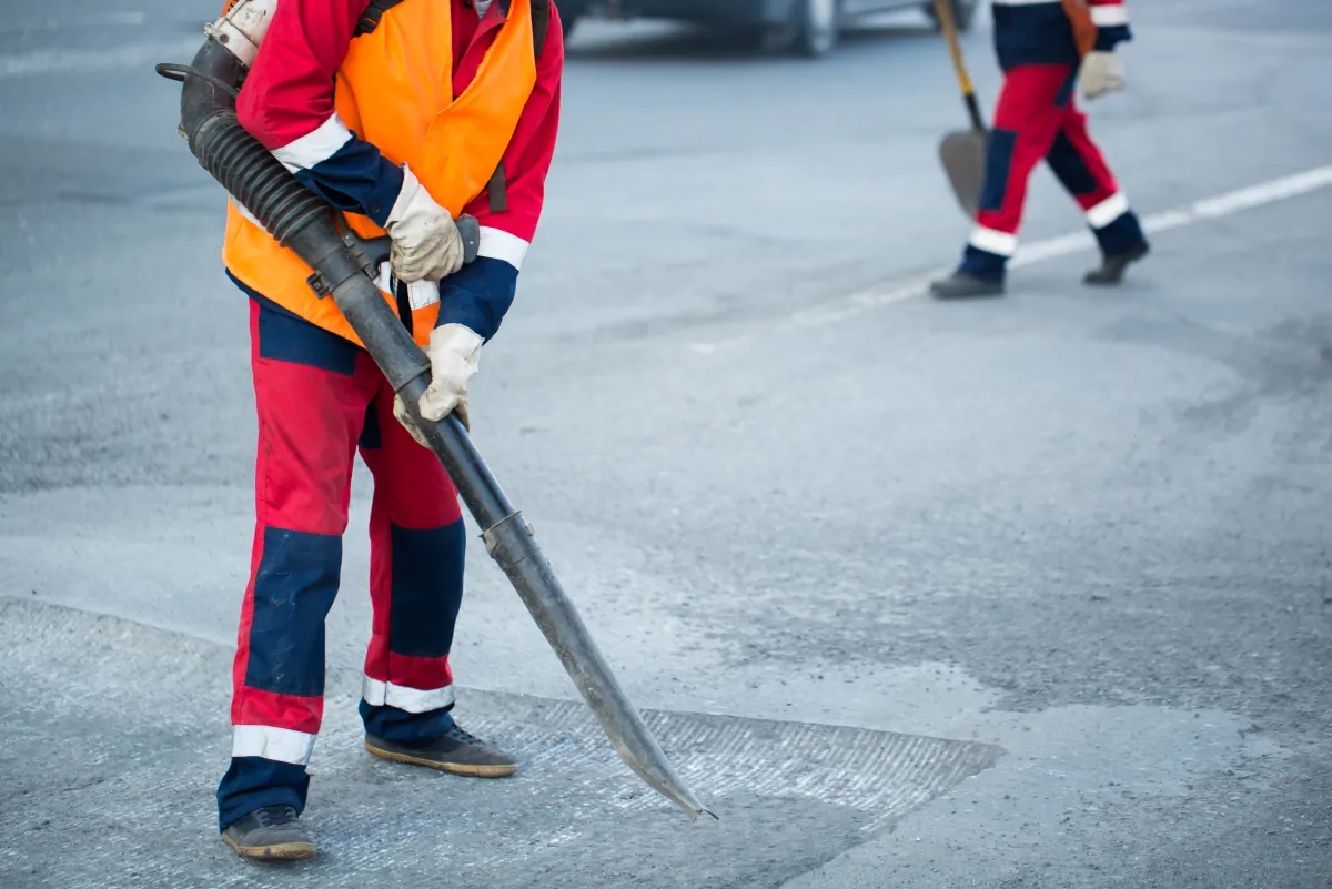 clean jobsite home protection worker with leaf blower cleaning out the dust