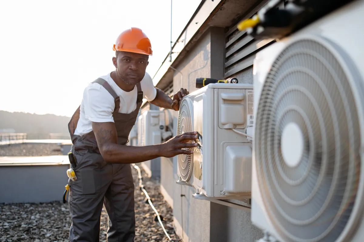 commercial african man uniform checking air conditioner construction cali