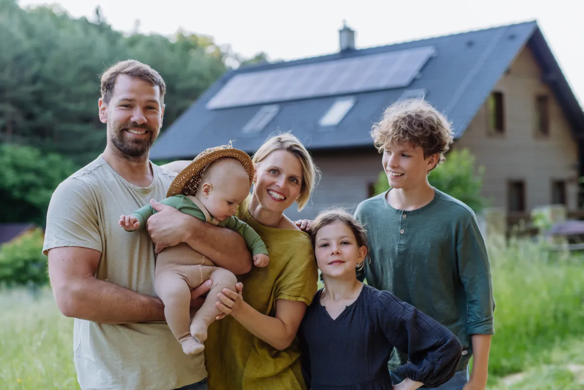 energy efficient upgrade expertise happy family near their house with solar panels