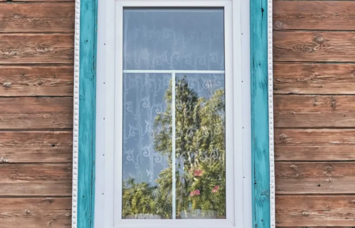 exterior window trim window with wooden carved turquoise white architra
