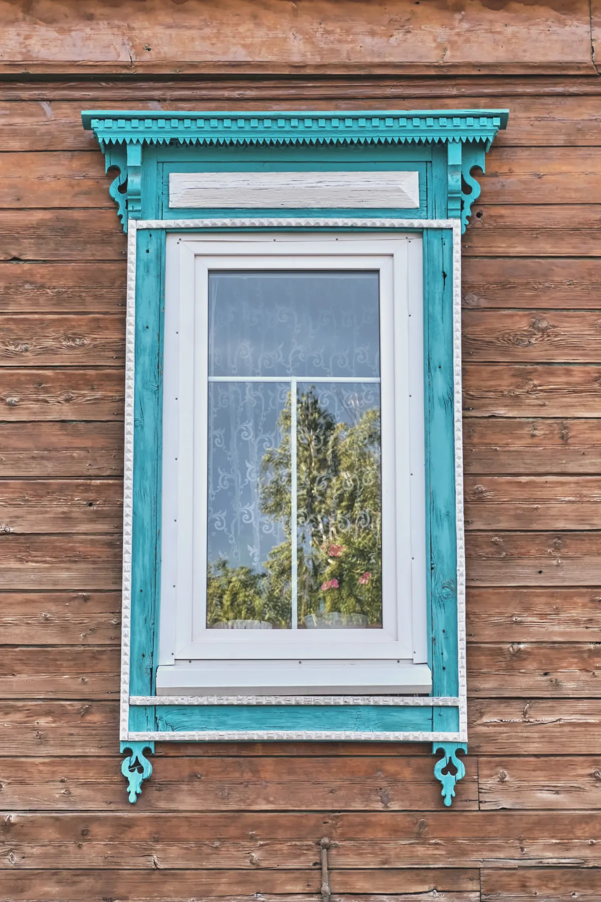 exterior window trim window with wooden carved turquoise white architra
