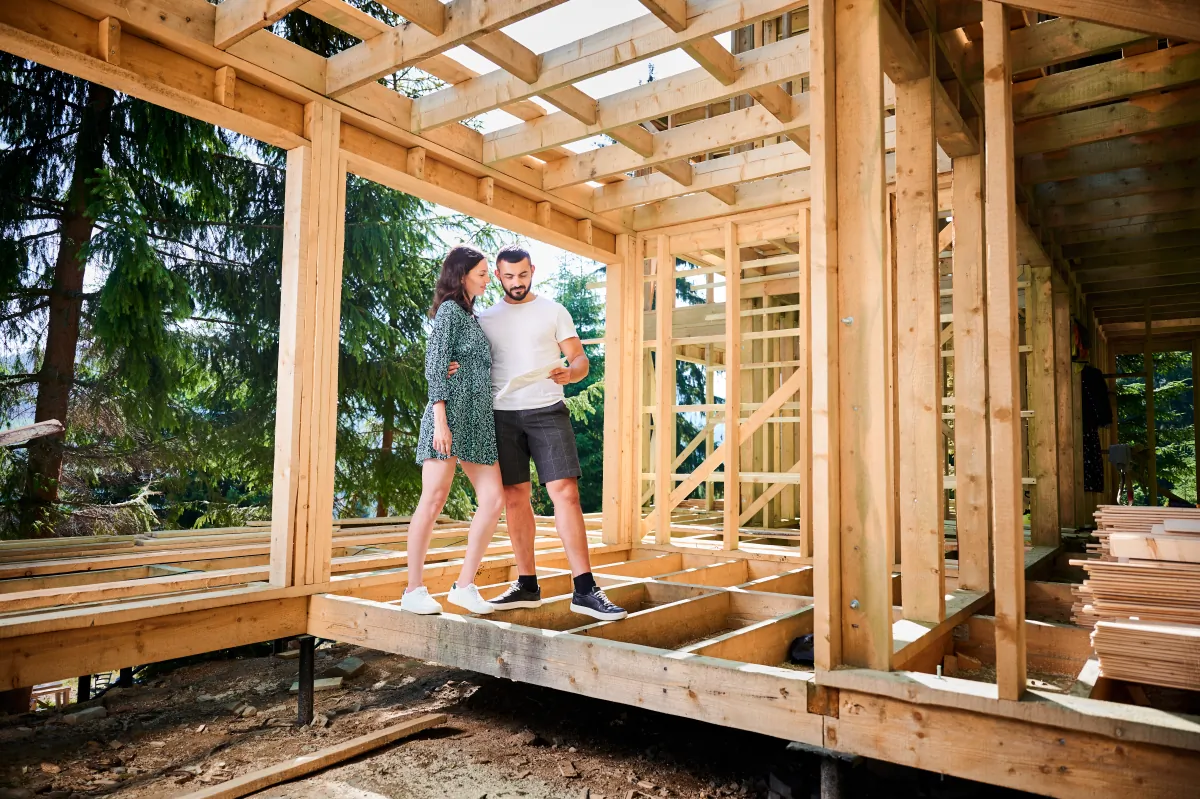 home additions man and woman inspecting their future wooden frame