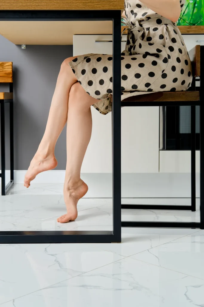 kitchen flooring barefoot female legs under the table