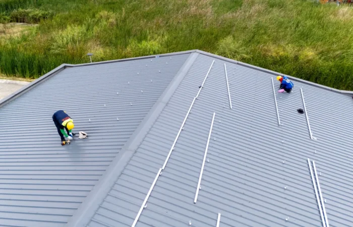 metal roof installation men technicians mounting photovoltaic solar moduls