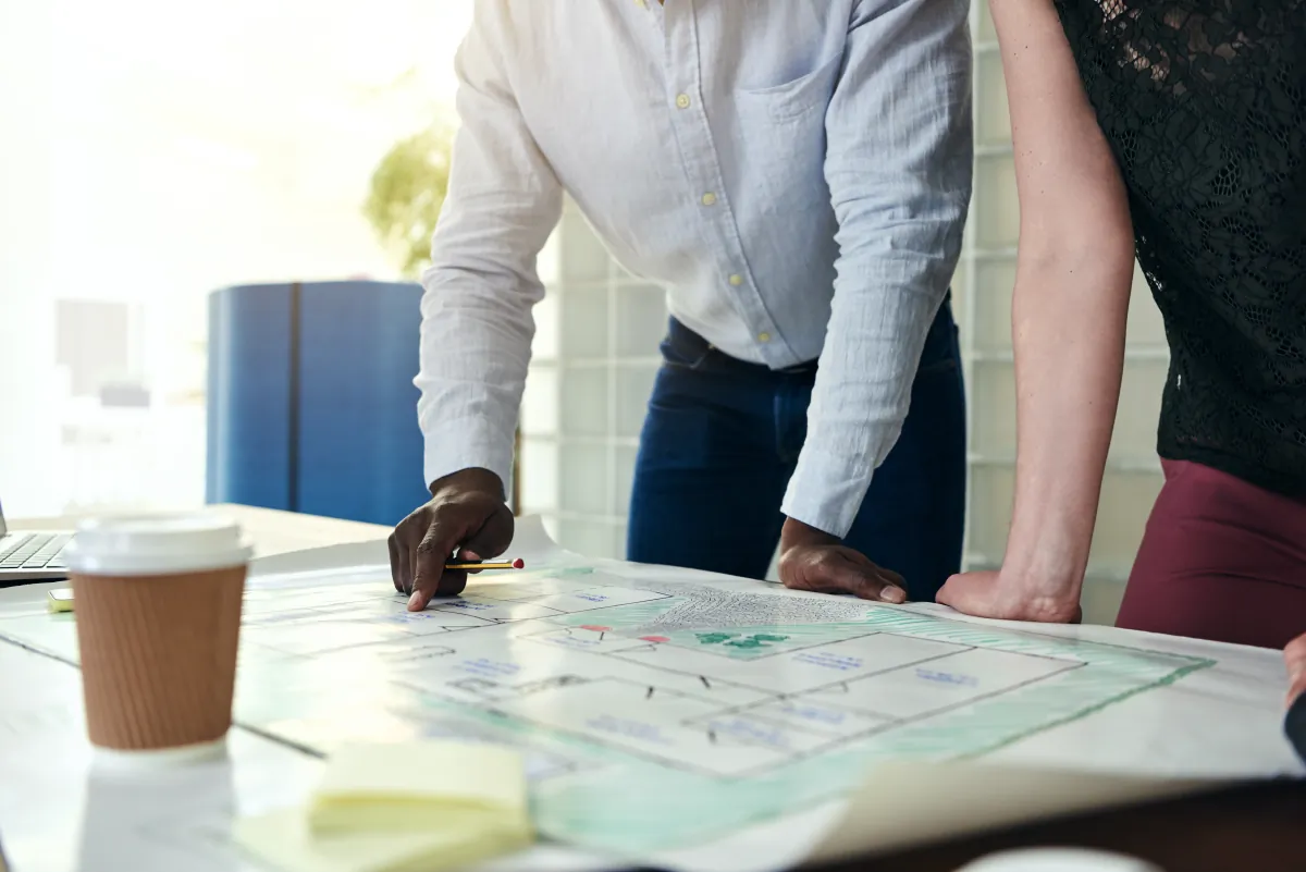 phased roadmapping architects discussing blueprints together table