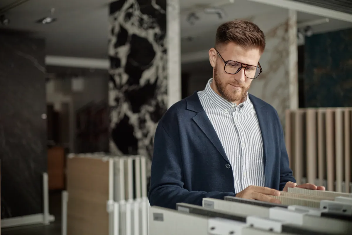 premium materials fair value caucasian young adult man examining samples mod