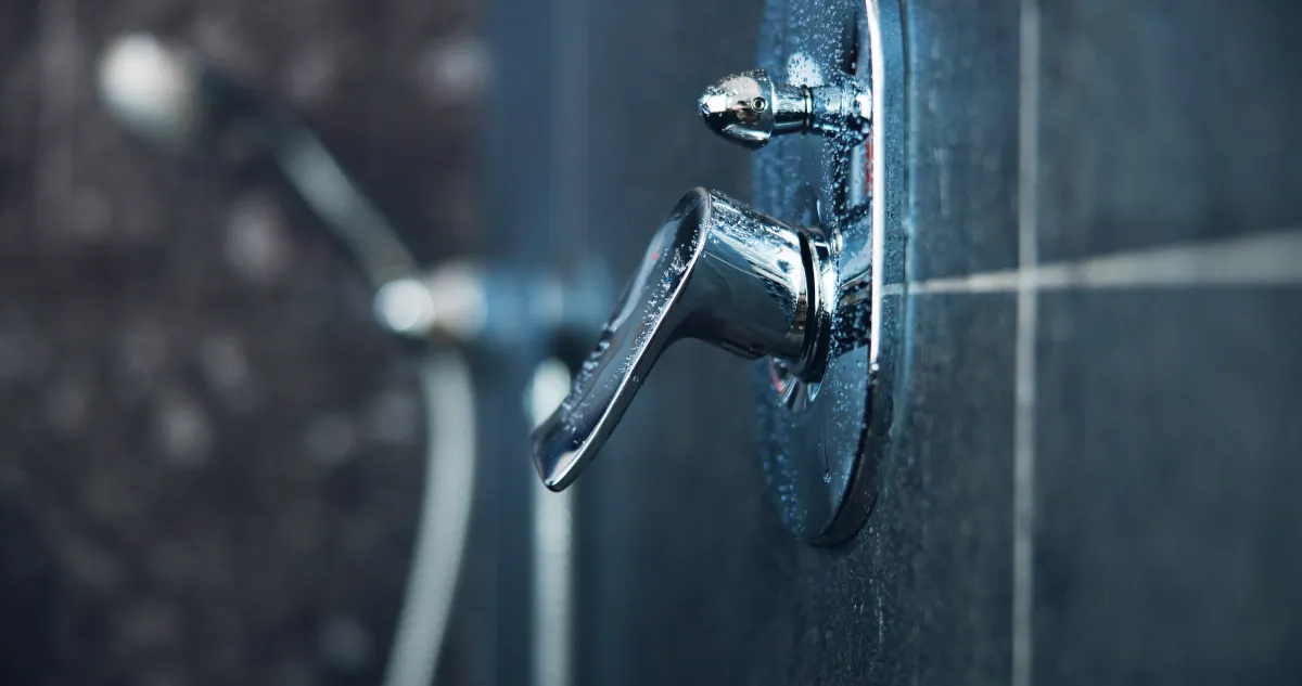 shower remodel shower handle and faucet closeup in bathroom for