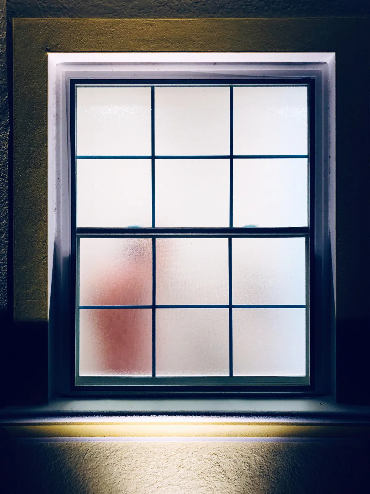 single hung window adult taking a shower behind the fogged glass wind