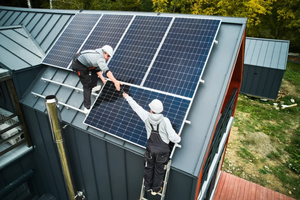 solar panel men workers installing solar panels on roof of hou