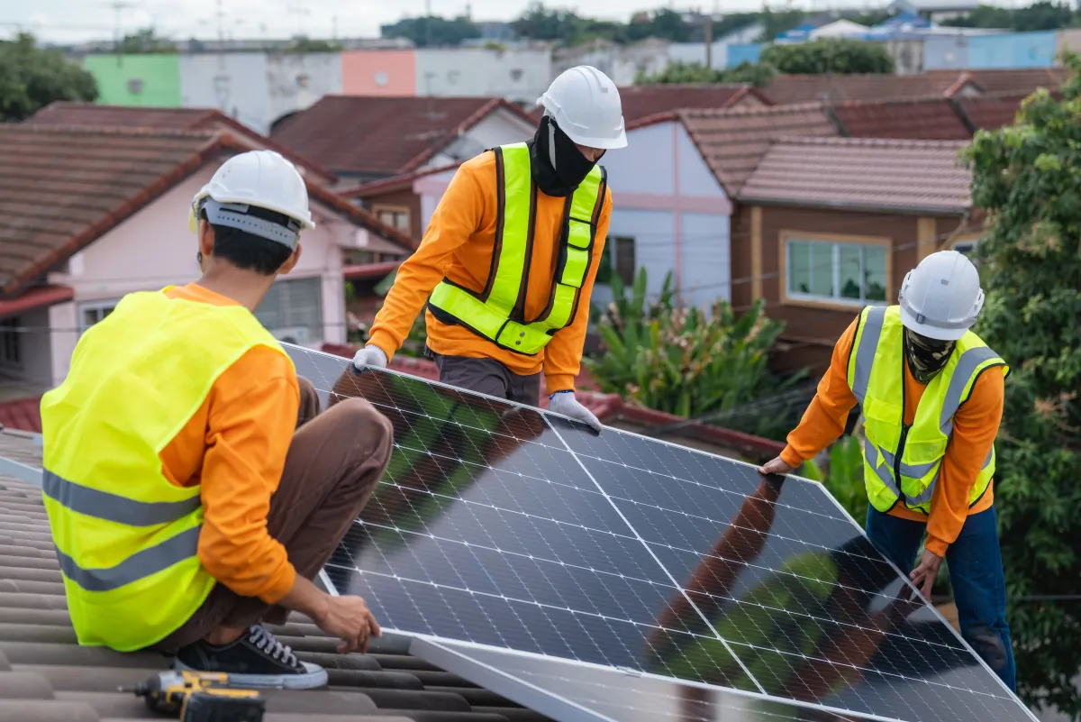 solar panel service engineer installing solar cell on the roof