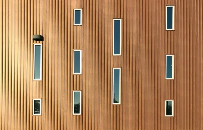 vertical siding building facade with many narrow windows
