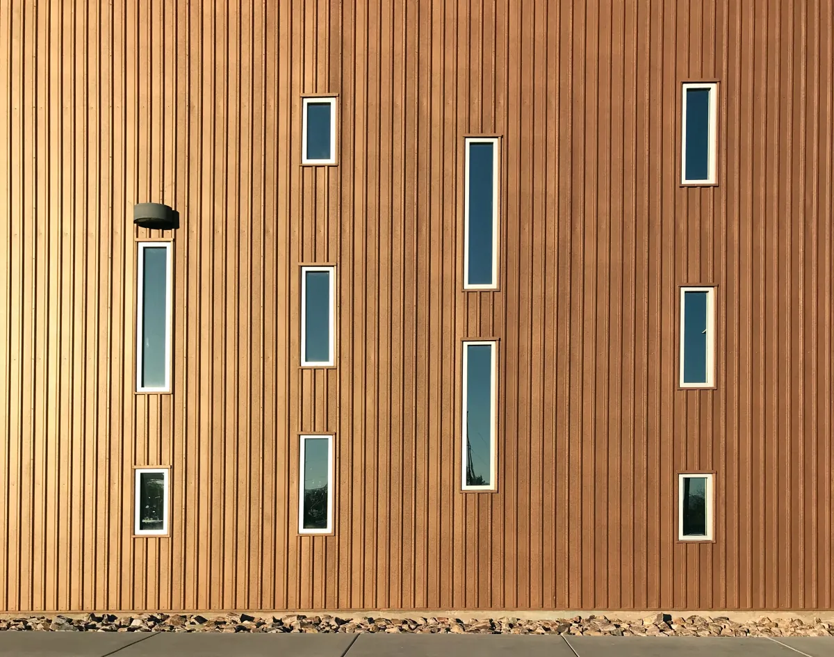 vertical siding building facade with many narrow windows