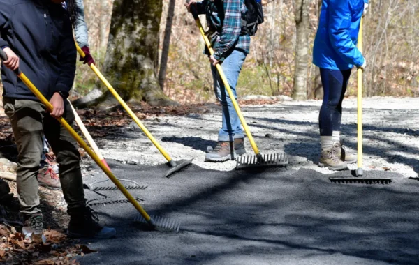 asphalt driveway base doing community service by spreading gravel with r