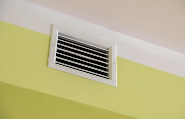 bathroom exhaust fan ventilation shaft with air grates on the ceiling