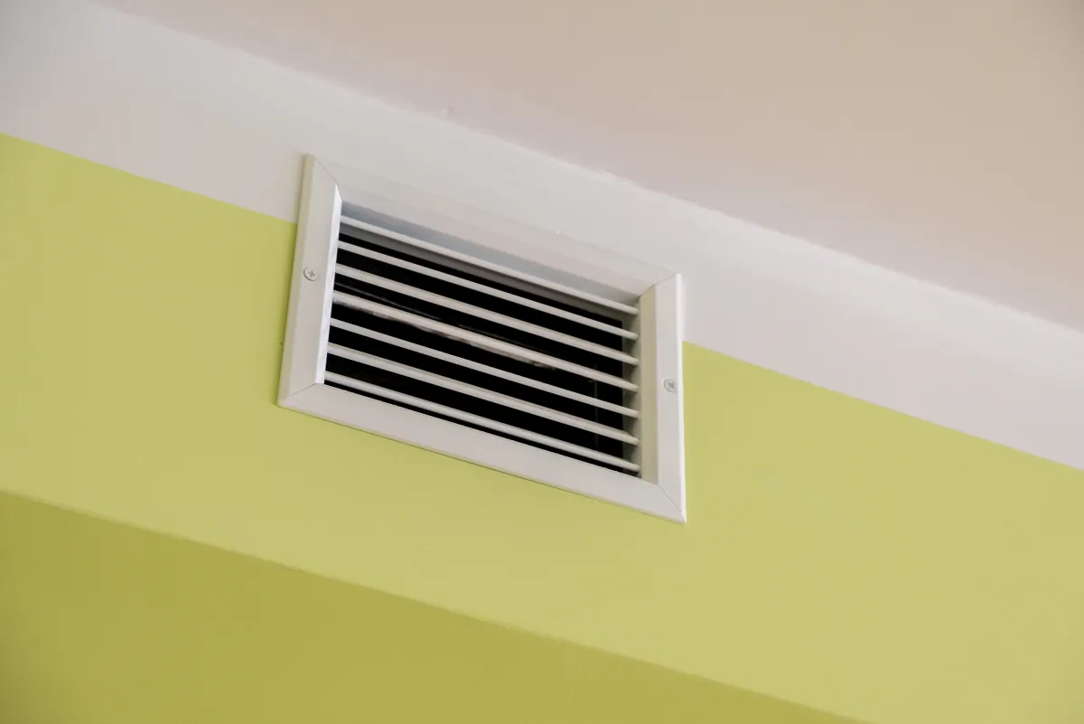 bathroom exhaust fan ventilation shaft with air grates on the ceiling