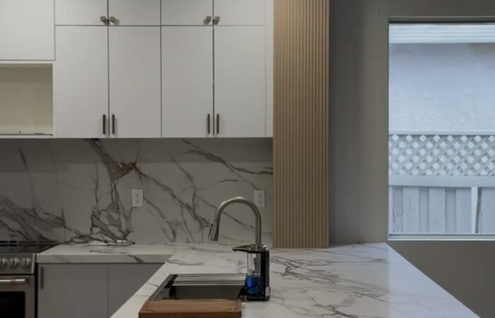 Completed Roseville kitchen remodel with waterfall quartz island and white cabinetry