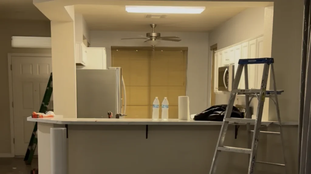 Original kitchen during early construction, aligned by the window and countertop to