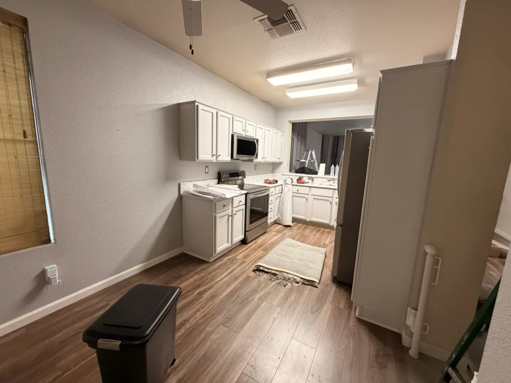 Wide view of the original kitchen during early construction before the new