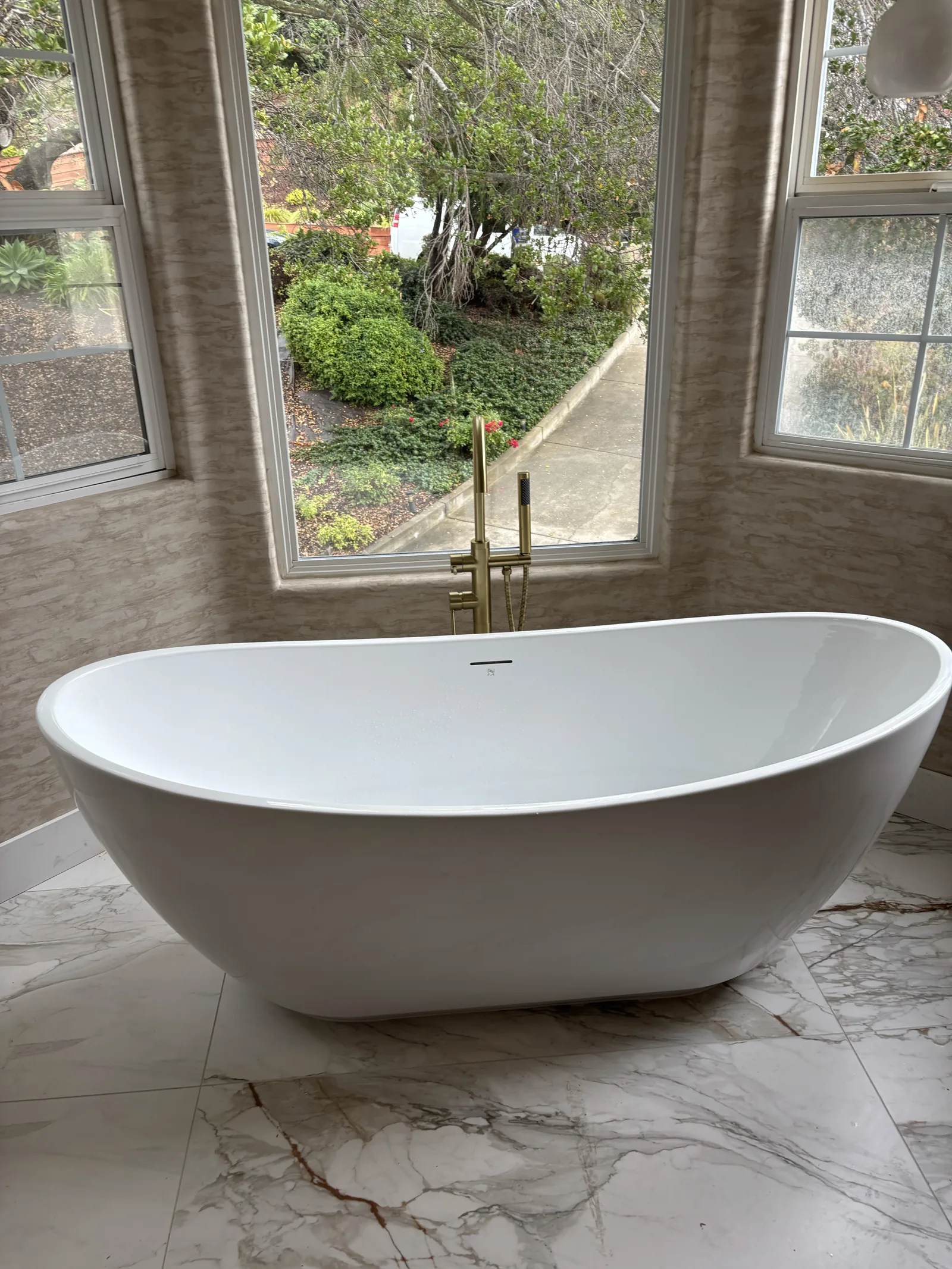 Completed freestanding bathtub with floor-mounted tub filler in a USC custom bathroom remodel.