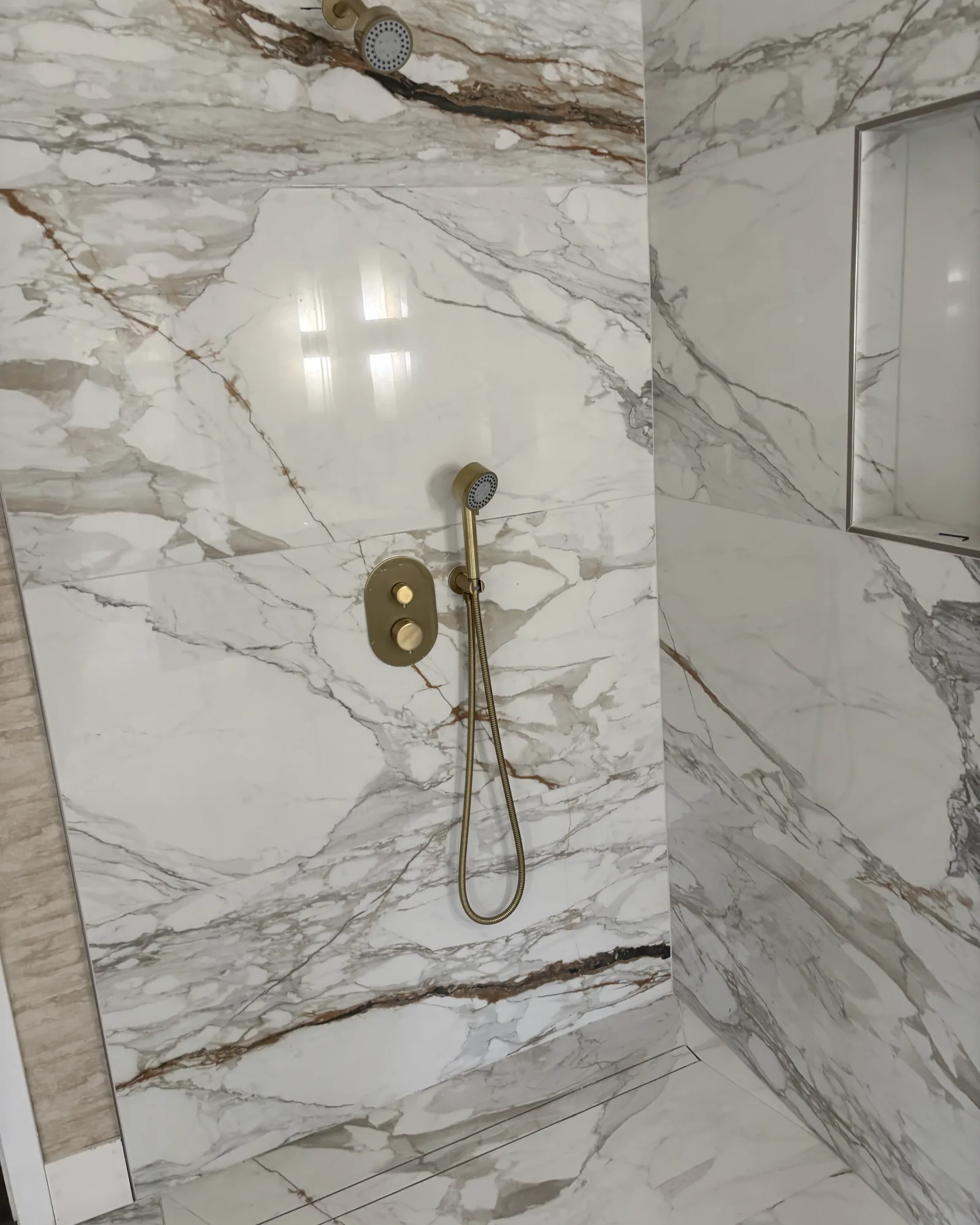 Completed custom shower with overhead and handheld fixtures