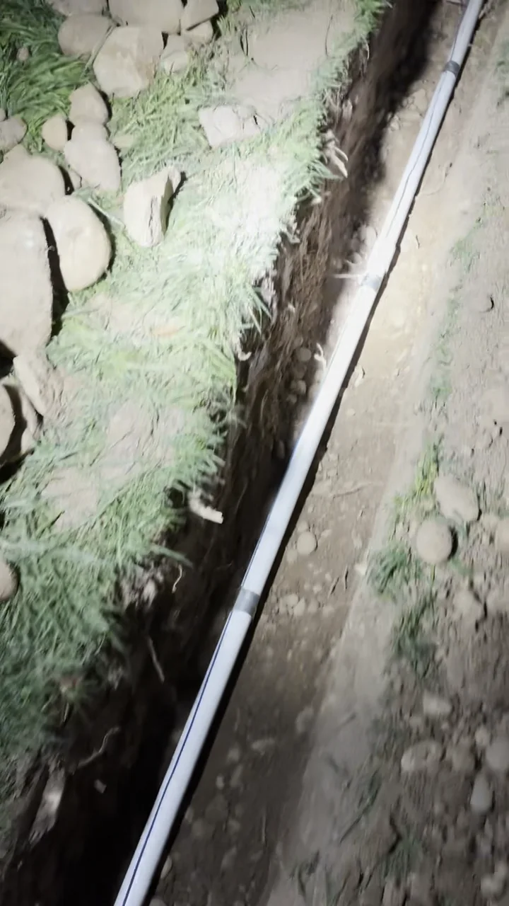 Long section of new main water line visible in the excavated route between the meter and house in Folsom.