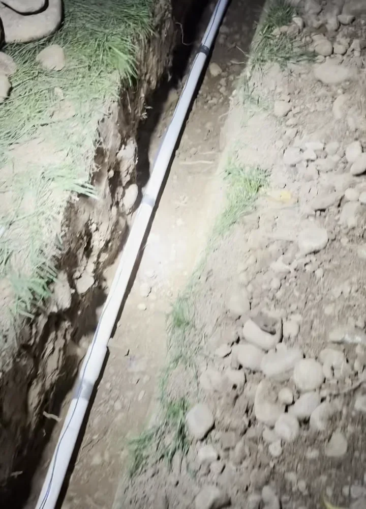 New residential main water line installed through a rock-heavy trench in Folsom.