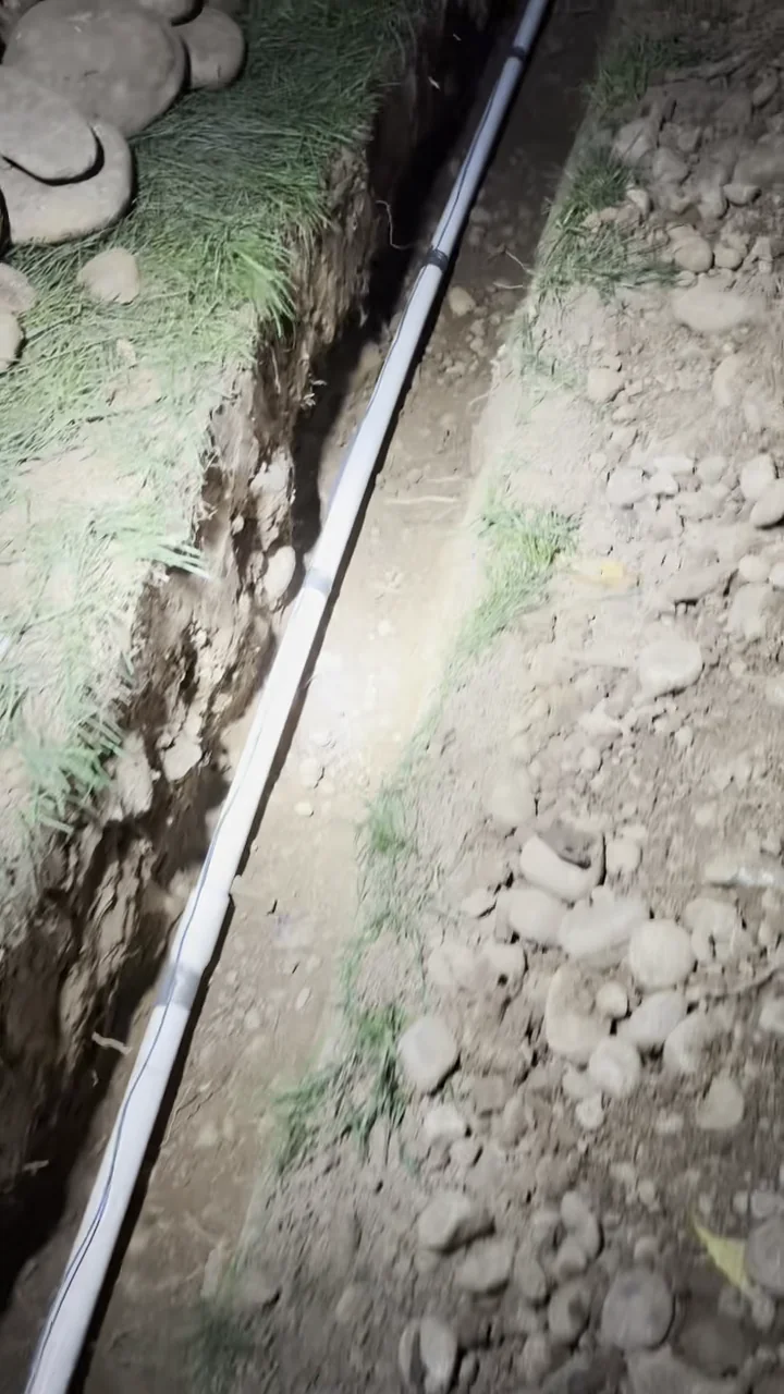 New residential main water line installed through a rock-heavy trench in Folsom.