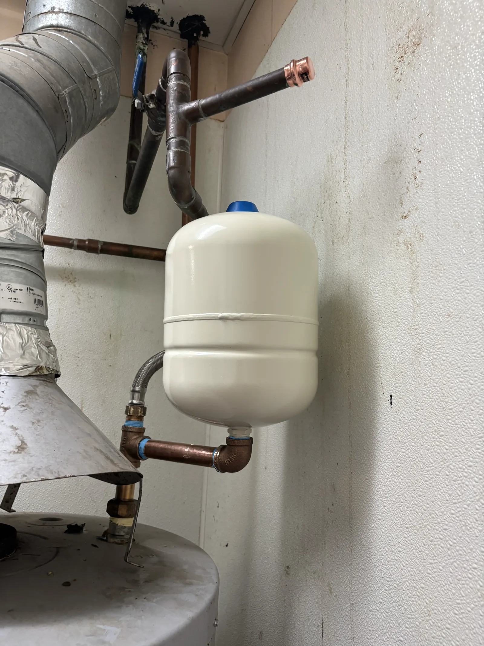 Expansion tank and accessible piping documented at the Old Sacramento commercial water-heater project.
