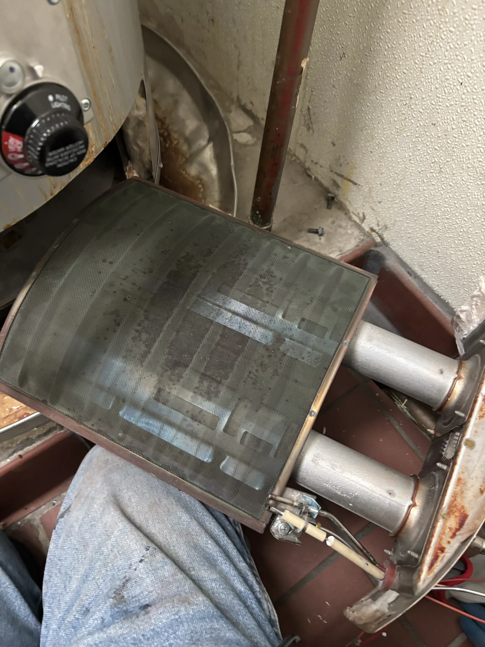 Burner and pilot assembly removed during diagnosis of an existing commercial gas water heater in Old Sacramento.