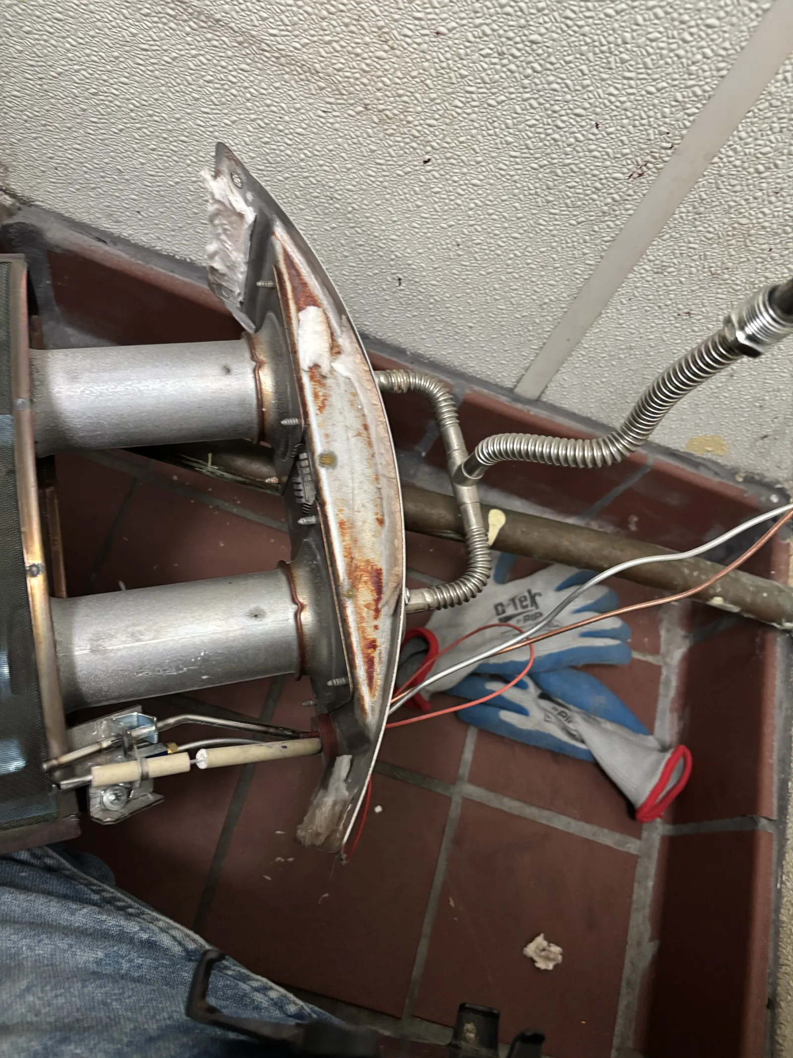 Close view of the burner and pilot assembly evaluated during a commercial no-hot-water service call.