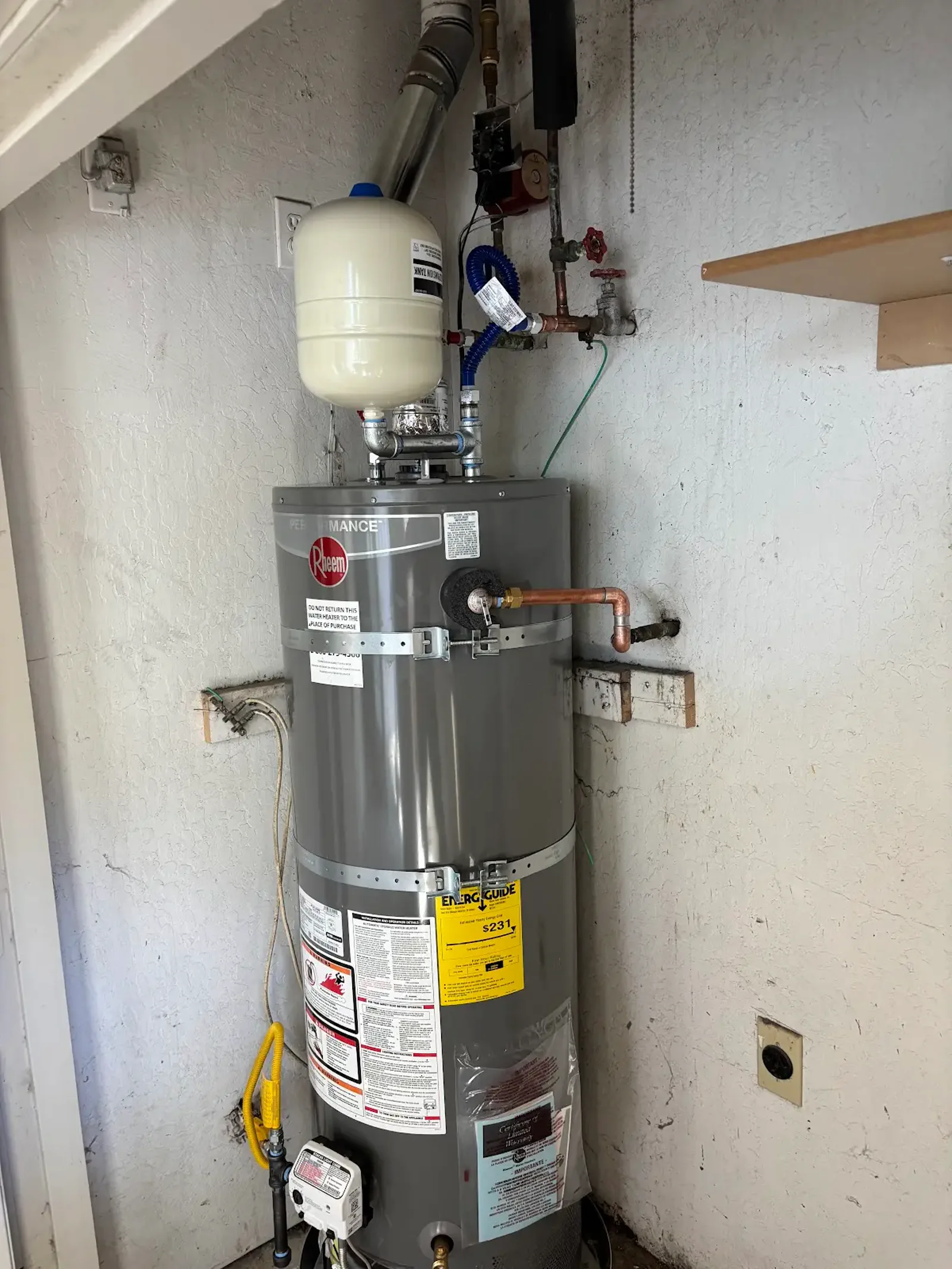 Full view of the completed Roseville gas water heater installation and its accessible gas, water, vent, and restraint components.