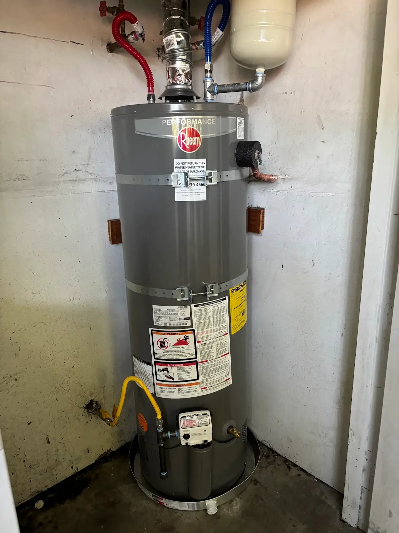 Completed Roseville gas water heater replacement showing the accessible gas connection, control, seismic straps, and drain pan.