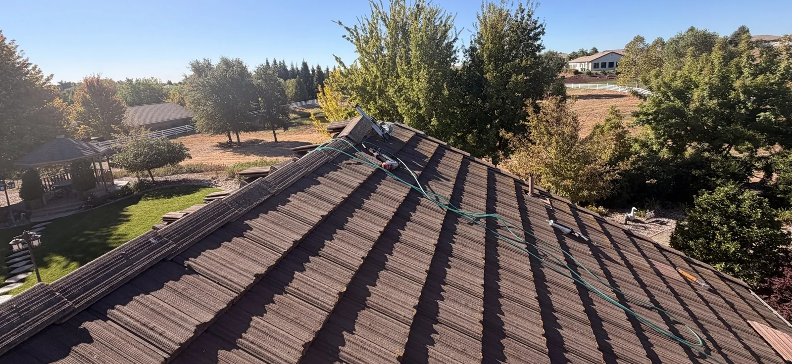 Completed tile roof repair showing the roof area and repaired edge at the Elk Grove residence