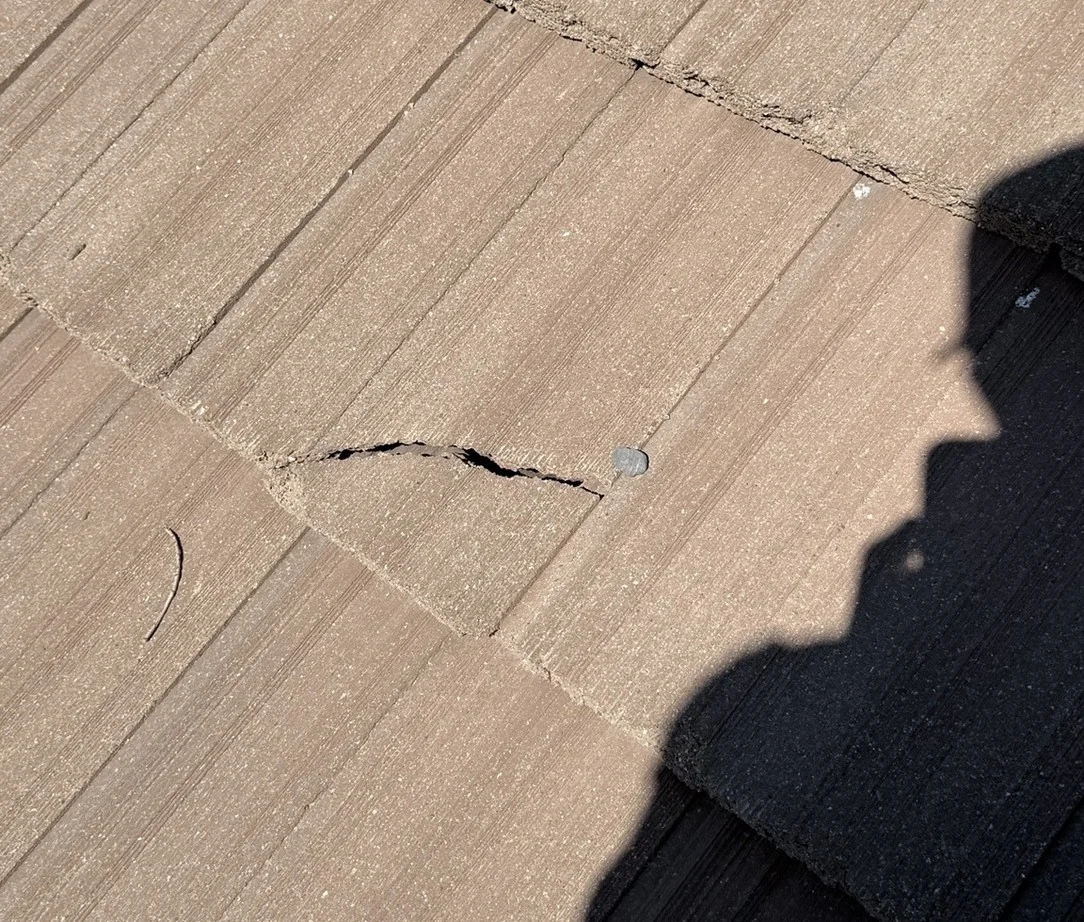 Close view of a cracked roof tile before the Elk Grove repair