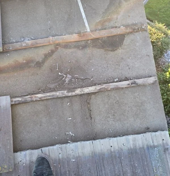 Exposed existing underlayment before local repairs beneath the Elk Grove roof tiles