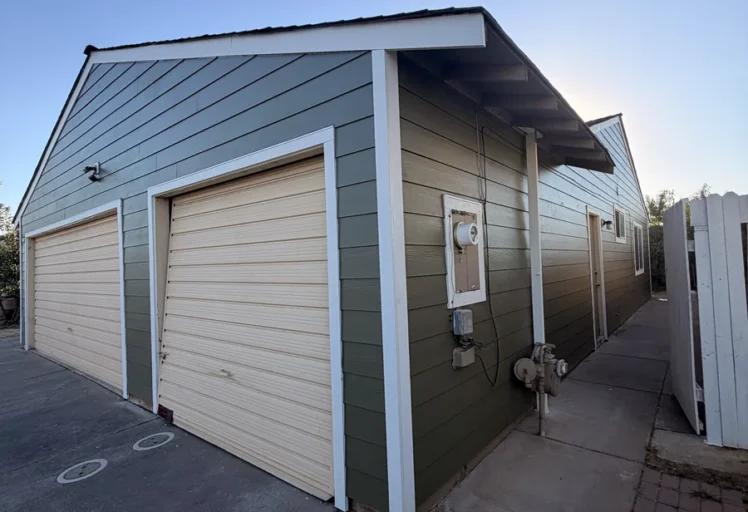 Completed James Hardie lap siding and white trim at the garage and sidewall of the Sacramento home