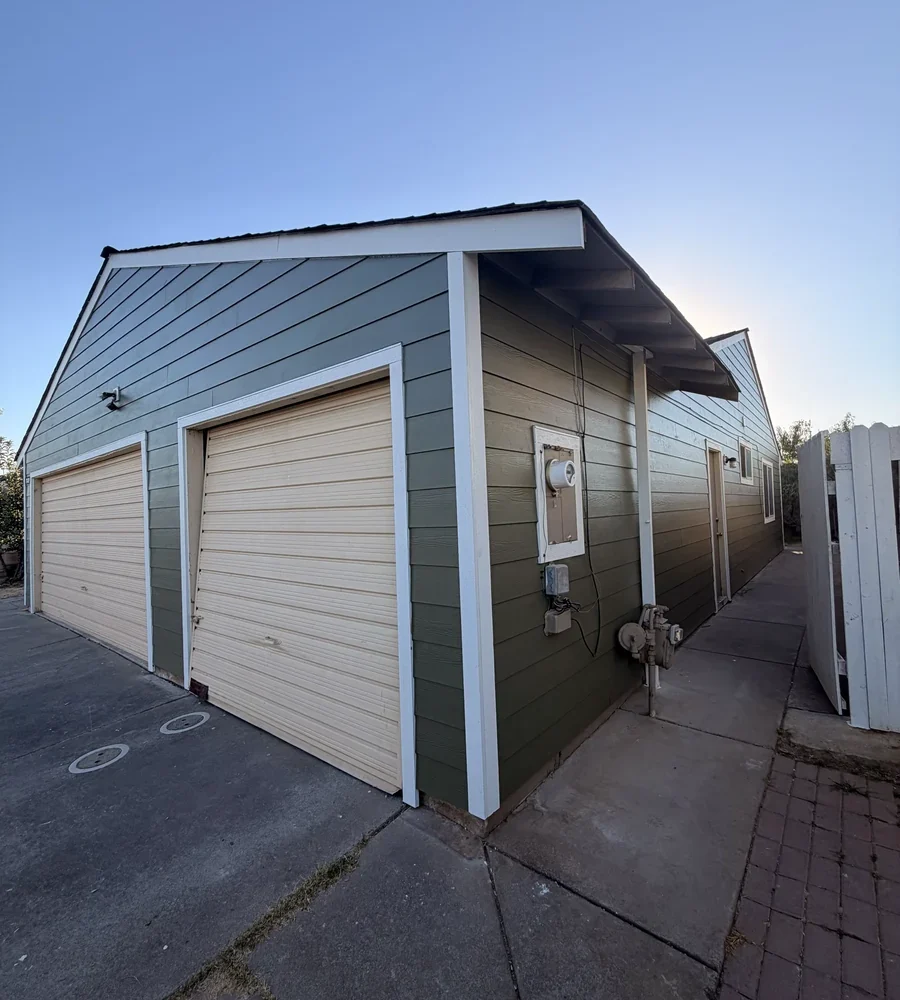 Completed James Hardie lap siding and white trim at the garage and sidewall of the Sacramento home