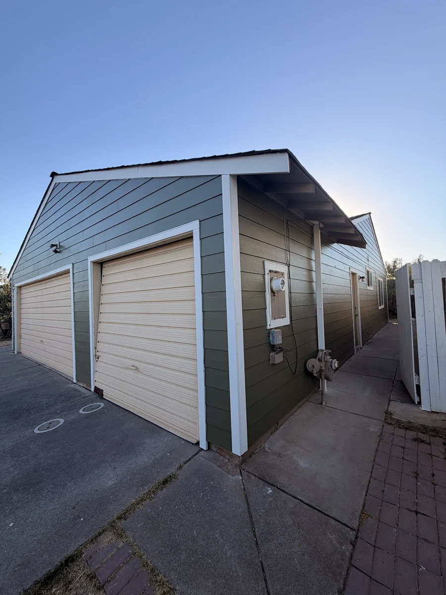 Completed James Hardie lap siding and white trim at the garage and sidewall of the Sacramento home