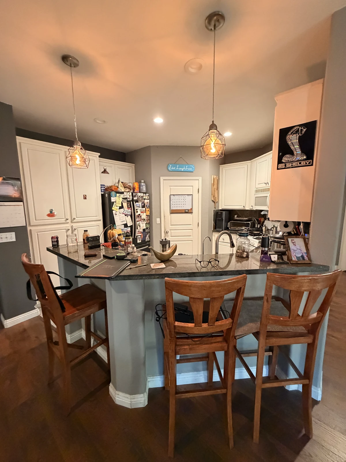 Original Sacramento kitchen with dark countertops and a raised peninsula before remodeling