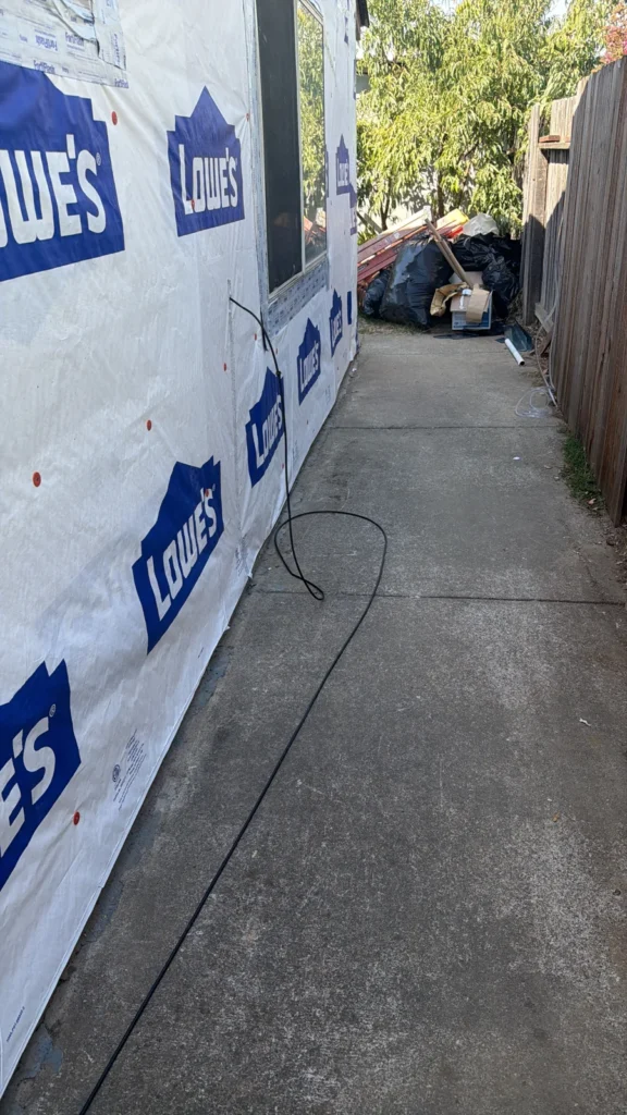 House wrap and preparation around an existing window during the siding replacement